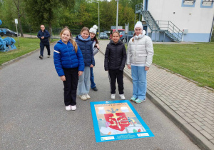 uczniowie przy ułożonych puzzlach z herbem miasta