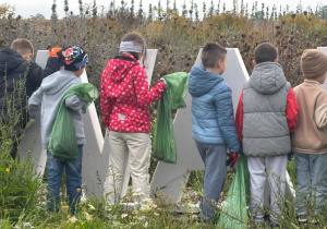 uczniowie w czasie sprzątania terenu Grodziska